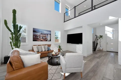 a kitchen with stainless steel appliances kitchen island granite countertop a stove a refrigerator a oven a sink with a dining table and chairs