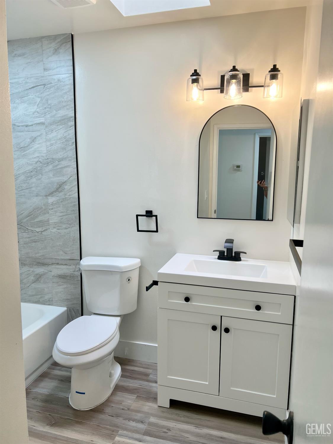 Undisclosed Address Bakersfield, CA 93308 - Photo 14 of 23 a bathroom with a toilet a sink and mirror