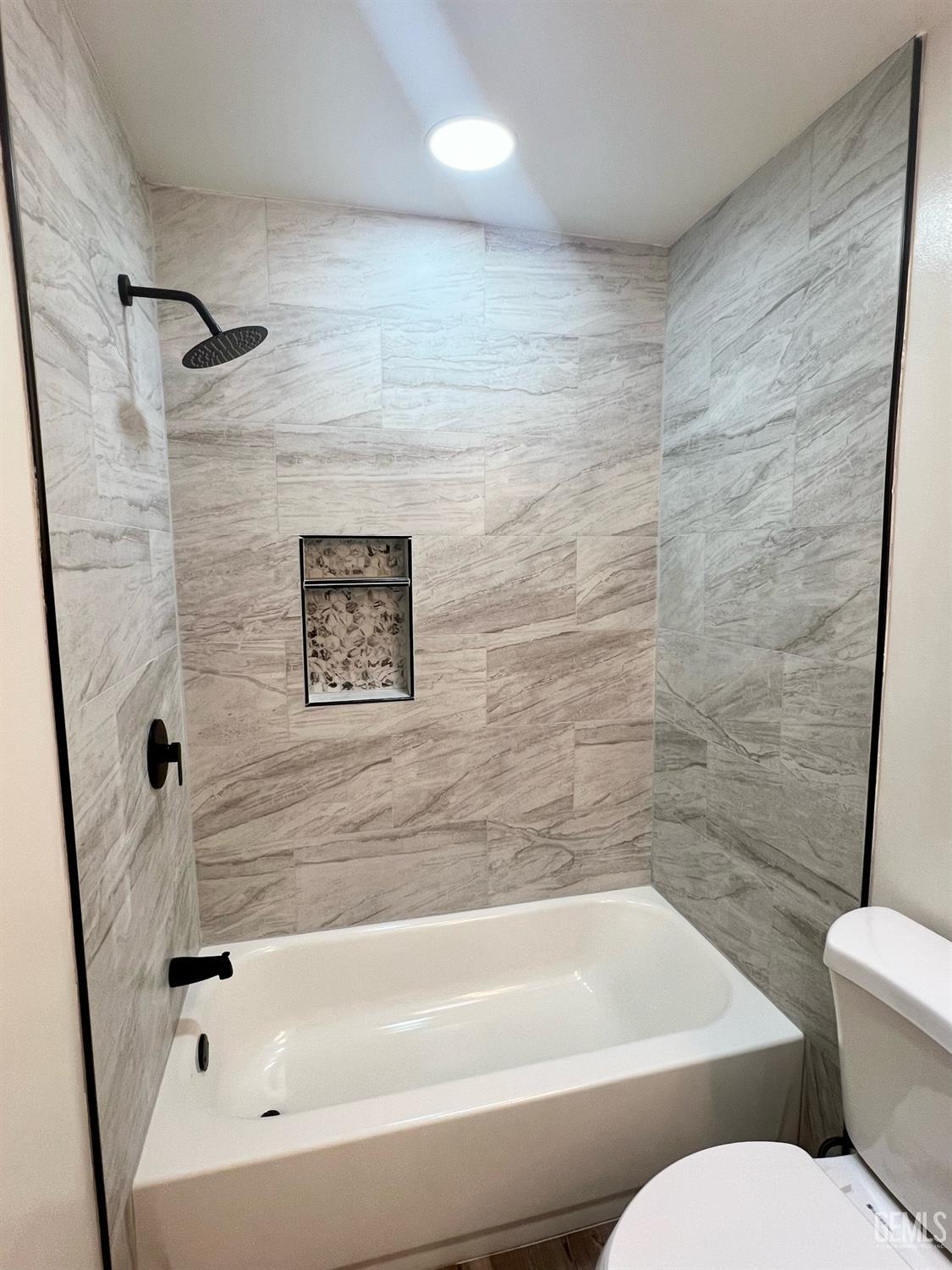 Undisclosed Address Bakersfield, CA 93308 - Photo 15 of 23 a bathroom with a toilet and a bathtub