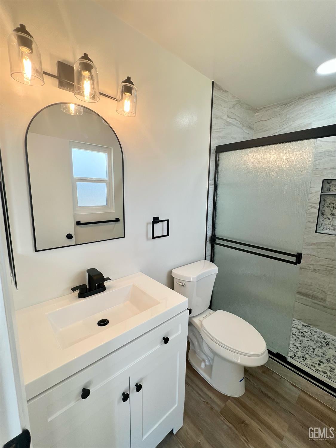 Undisclosed Address Bakersfield, CA 93308 - Photo 18 of 23 a bathroom with a toilet sink and mirror