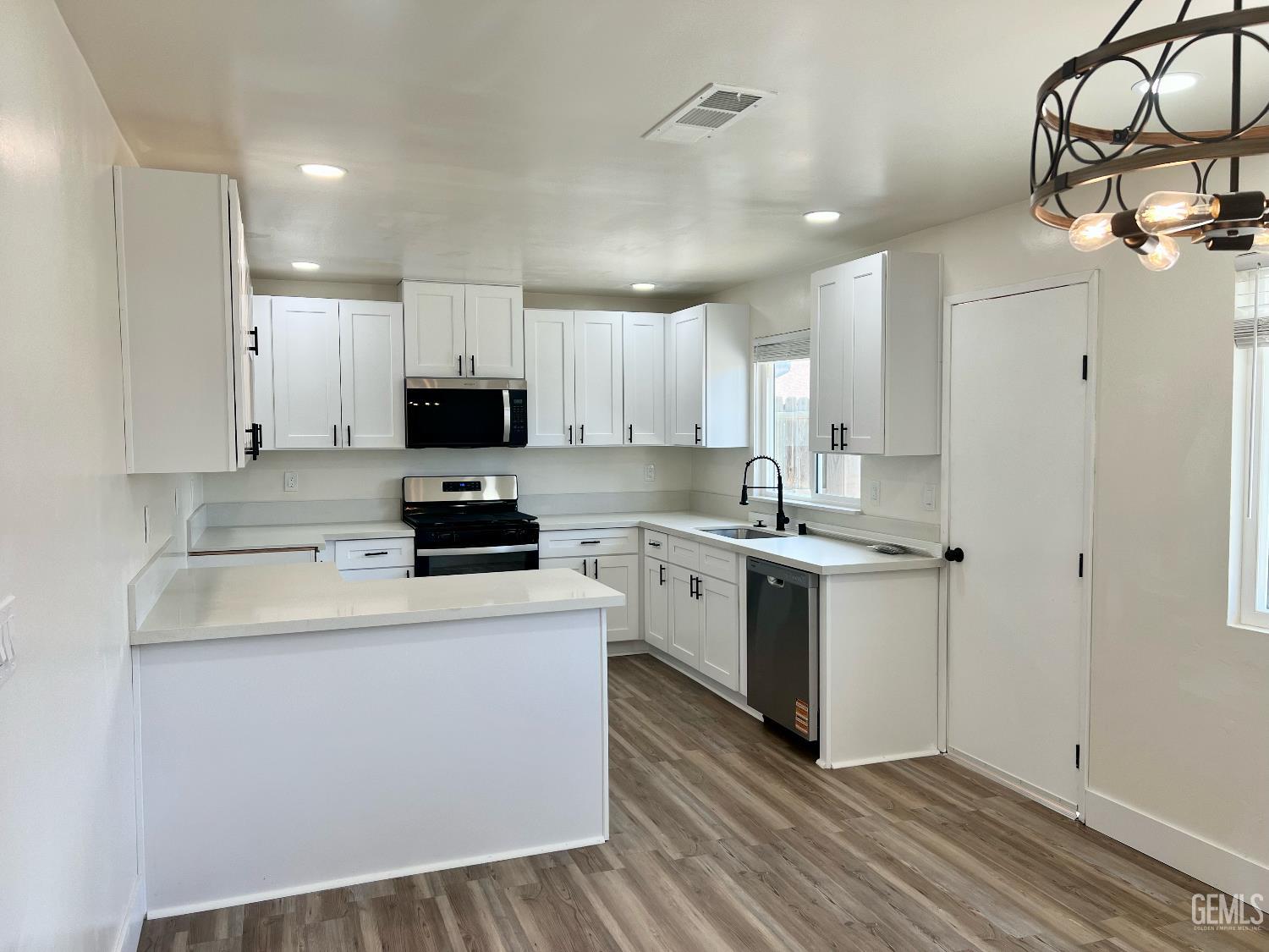 Undisclosed Address Bakersfield, CA 93308 - Photo 10 of 23 a kitchen with granite countertop a sink stove and refrigerator