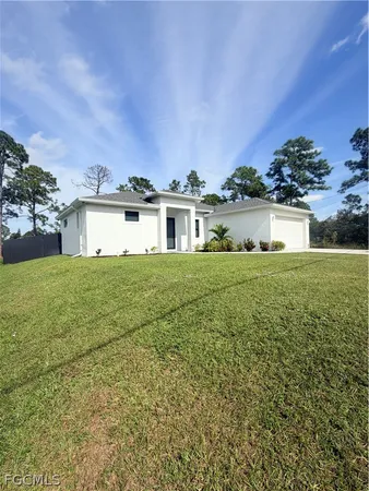 a view of a house with a big yard and potted plants