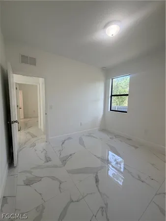 a view of a house with a yard and a large tree center in front of it