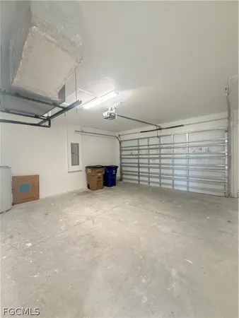 a view of a large pool with lawn chairs and large trees