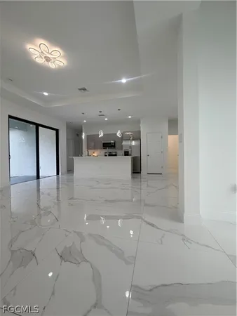 an empty room with a empty space and windows