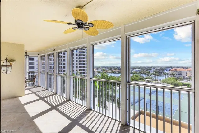 a view of a living room with a floor to ceiling window and a ceiling fan