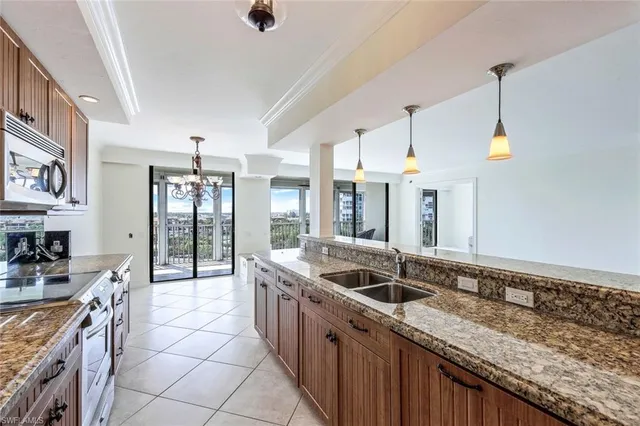 a kitchen with stainless steel appliances granite countertop a sink and a stove
