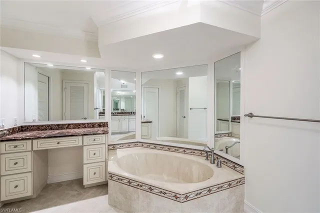 a bathroom with a granite countertop sink mirror and bathtub