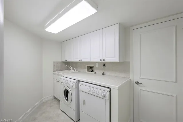 a utility room with sink dryer and washer