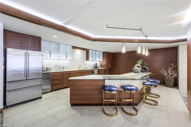 a kitchen with a table chairs refrigerator and cabinets