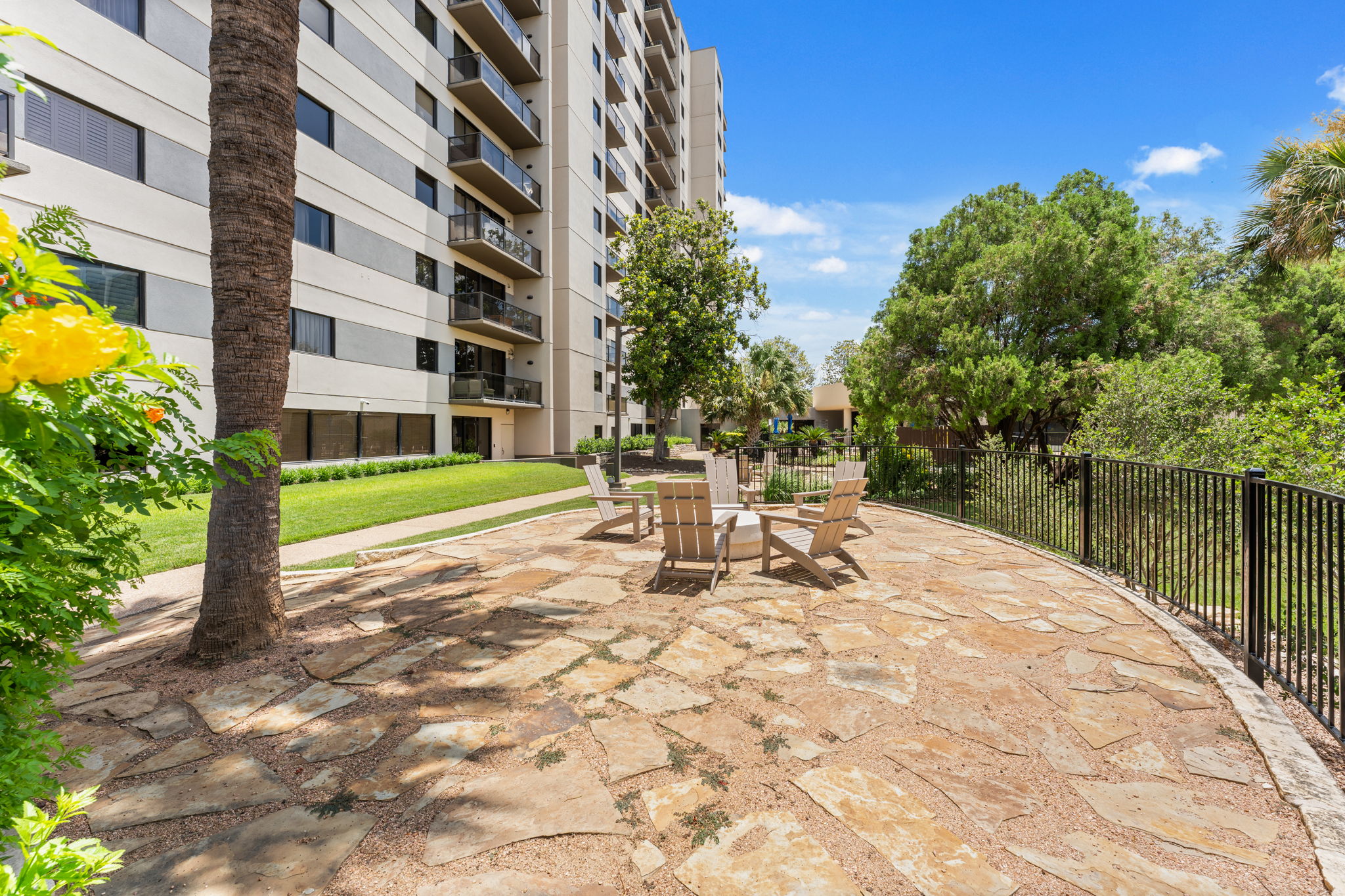 40 North Interstate Highway 35, Unit 11B2 Austin, TX 78701 - Photo 25 of 28 An inviting stone patio with comfortable seating is perfect for enjoying the vibrant outdoor setting.
