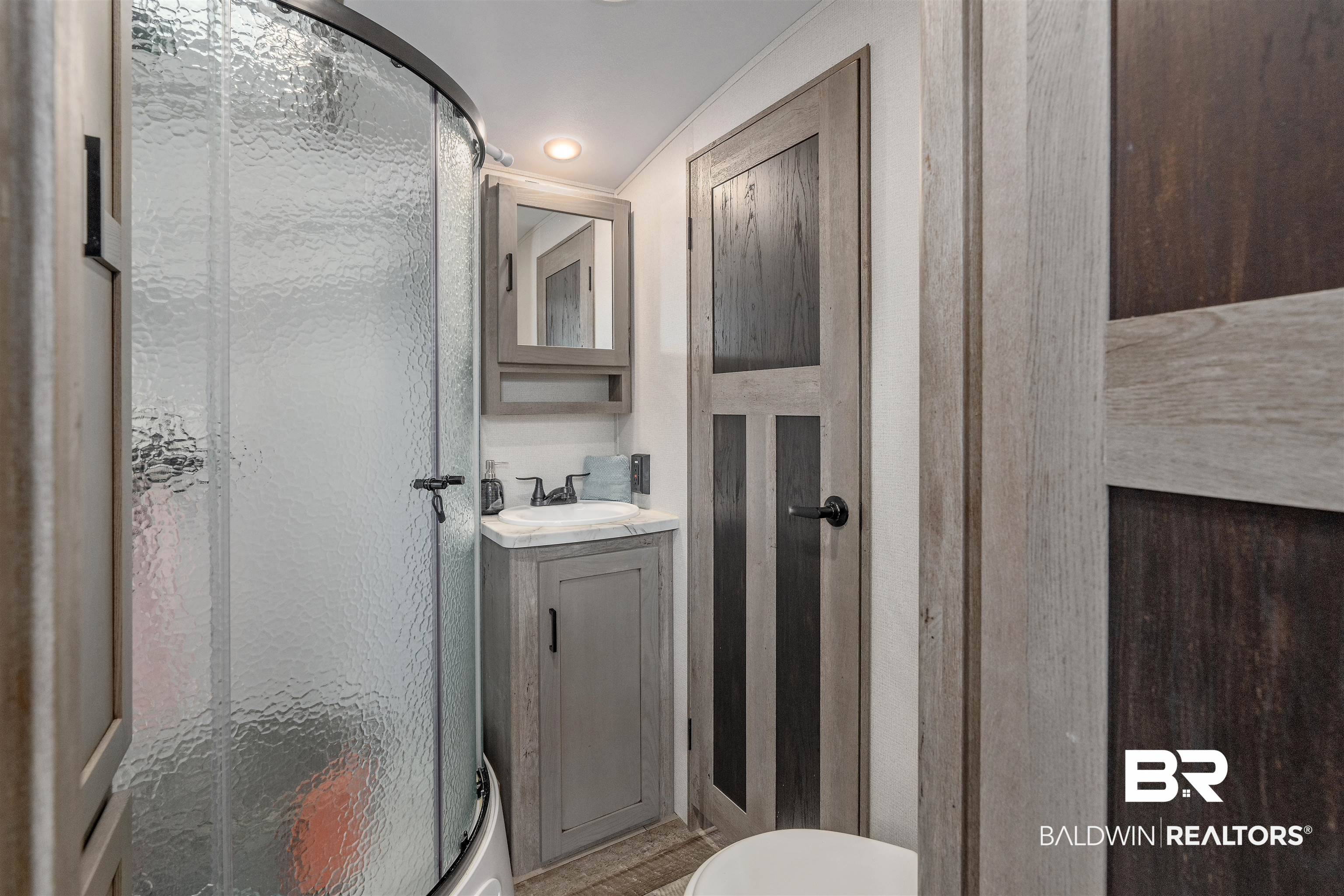 683 Escambia Loop Lillian, AL 36549 - Photo 10 of 27 Bathroom with toilet, vanity, and walk in shower