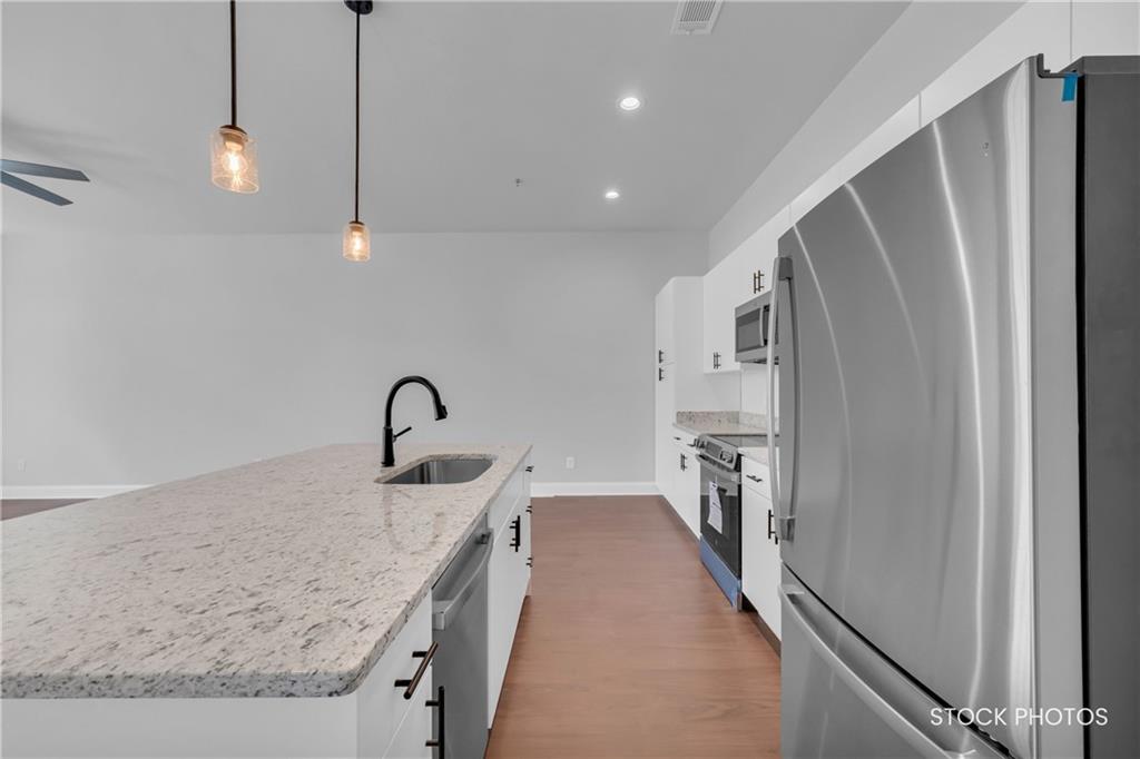 1038 Homestead Way Street Dacula, GA 30019 - Photo 13 of 36 a view of a kitchen with a sink and dishwasher