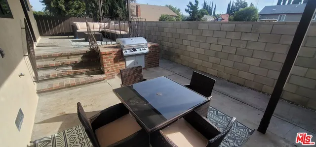 a terrace of a house with outdoor seating