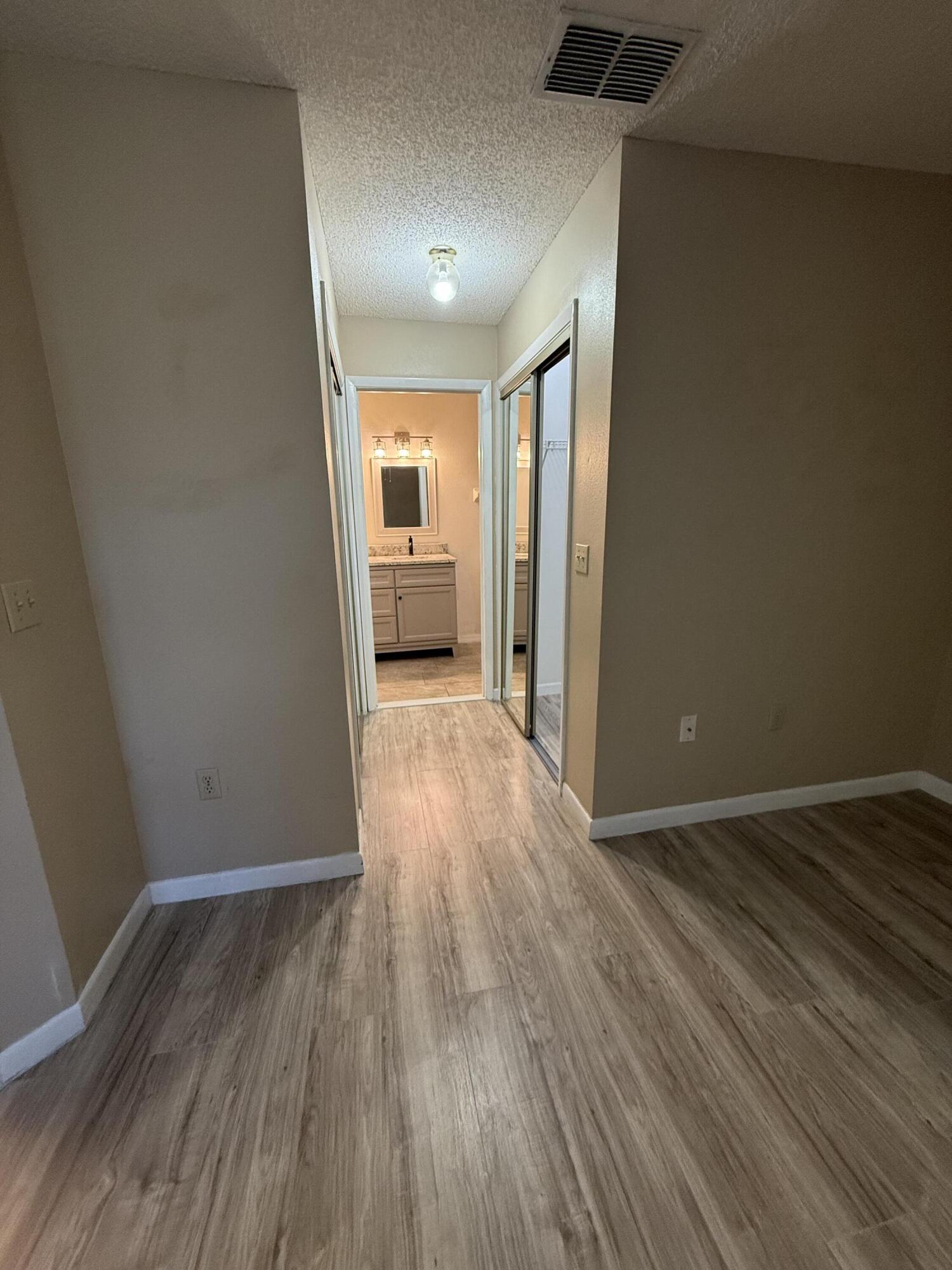 683 Post Oak Circle, Unit 105 Altamonte Springs, FL 32701 - Photo 18 of 22 a view of a hallway with wooden floor