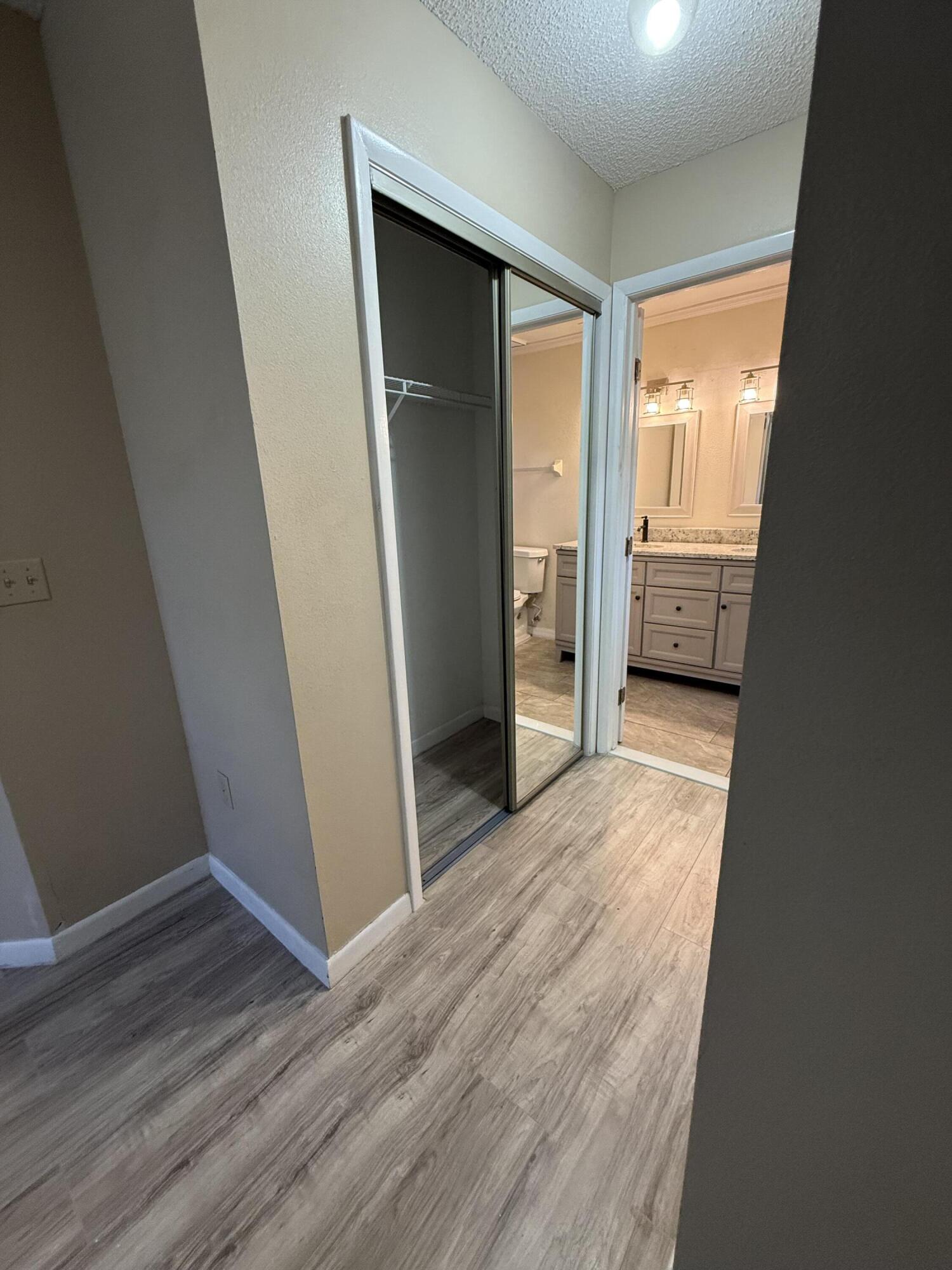 683 Post Oak Circle, Unit 105 Altamonte Springs, FL 32701 - Photo 19 of 22 an empty room with wooden floor and a window