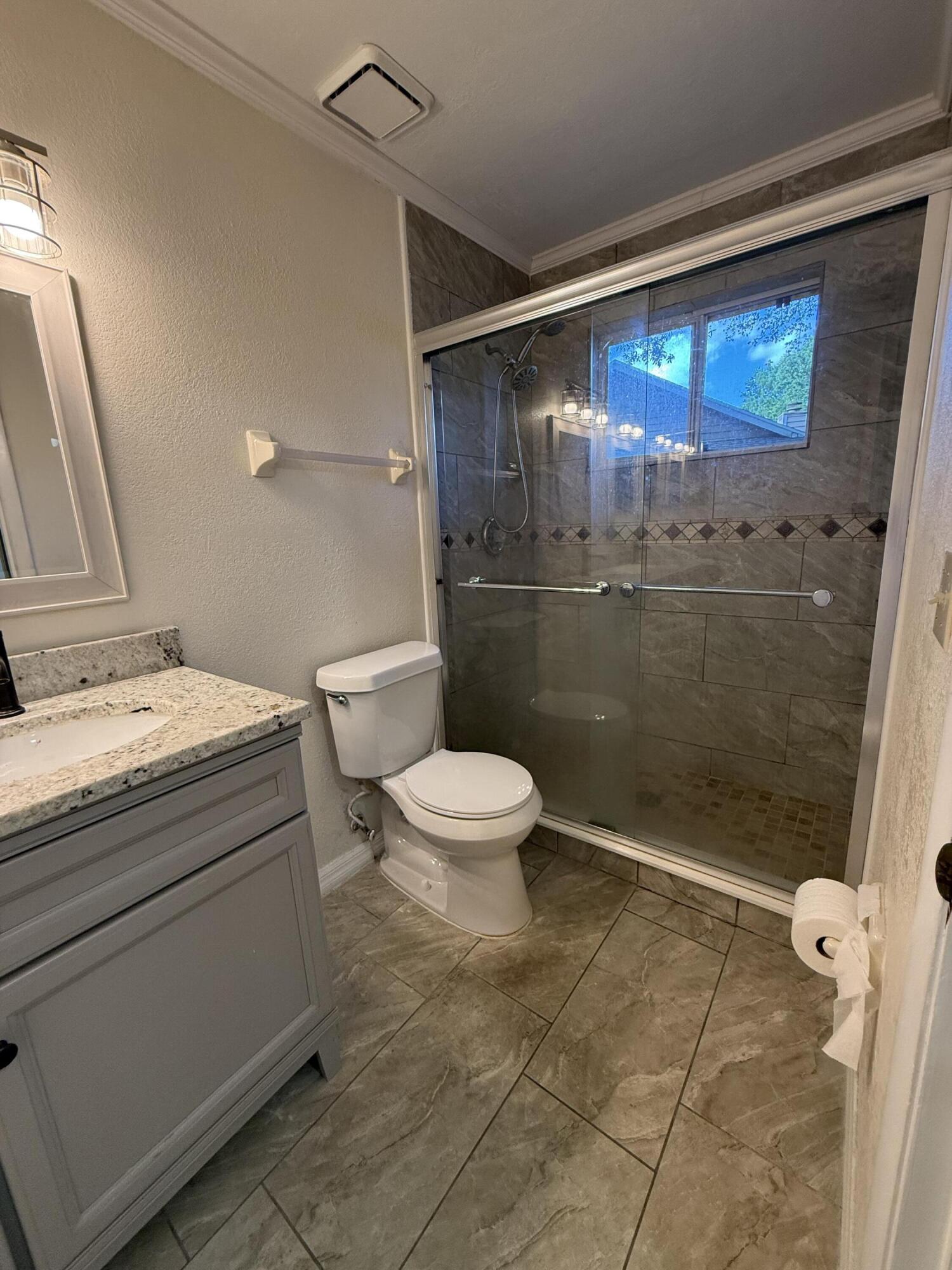 683 Post Oak Circle, Unit 105 Altamonte Springs, FL 32701 - Photo 21 of 22 a bathroom with a toilet a sink and shower