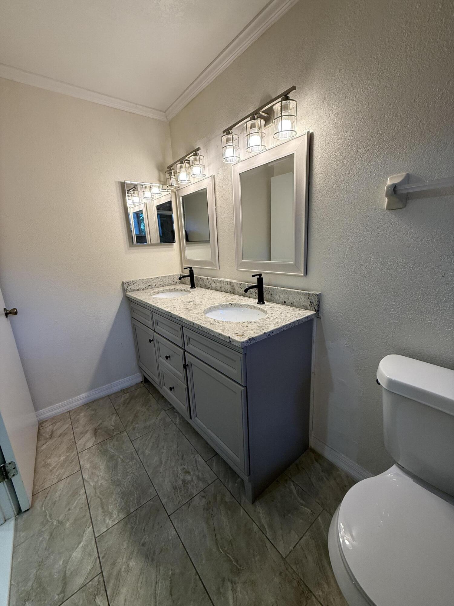 683 Post Oak Circle, Unit 105 Altamonte Springs, FL 32701 - Photo 22 of 22 a bathroom with a toilet sink and mirror