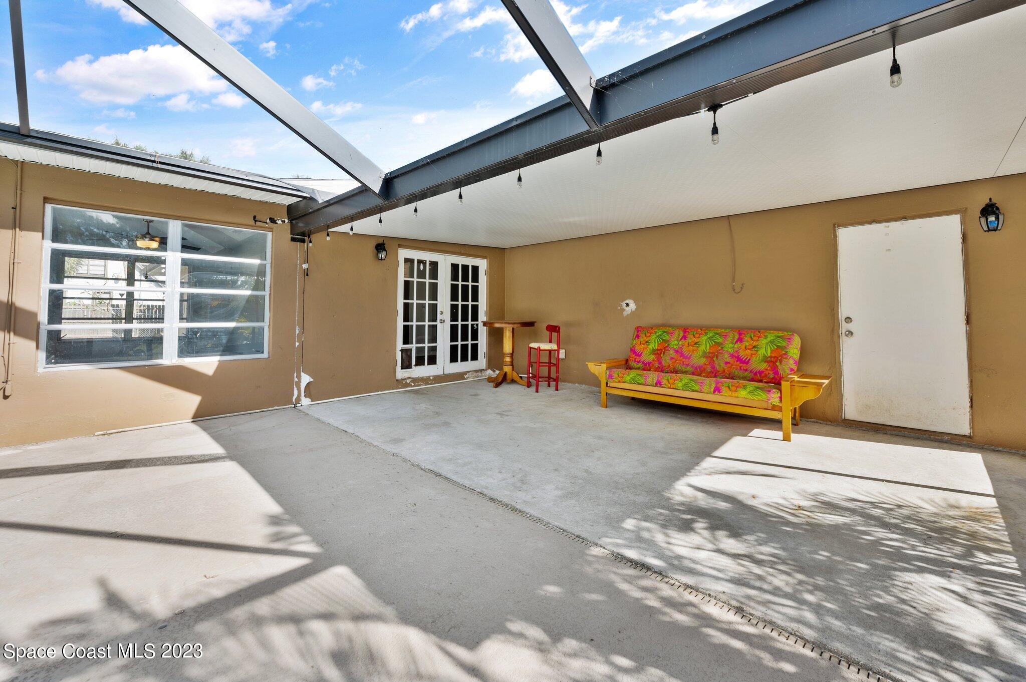 3030 Hield Road Melbourne, FL 32904 - Photo 16 of 36 a bedroom with a bed and a large window