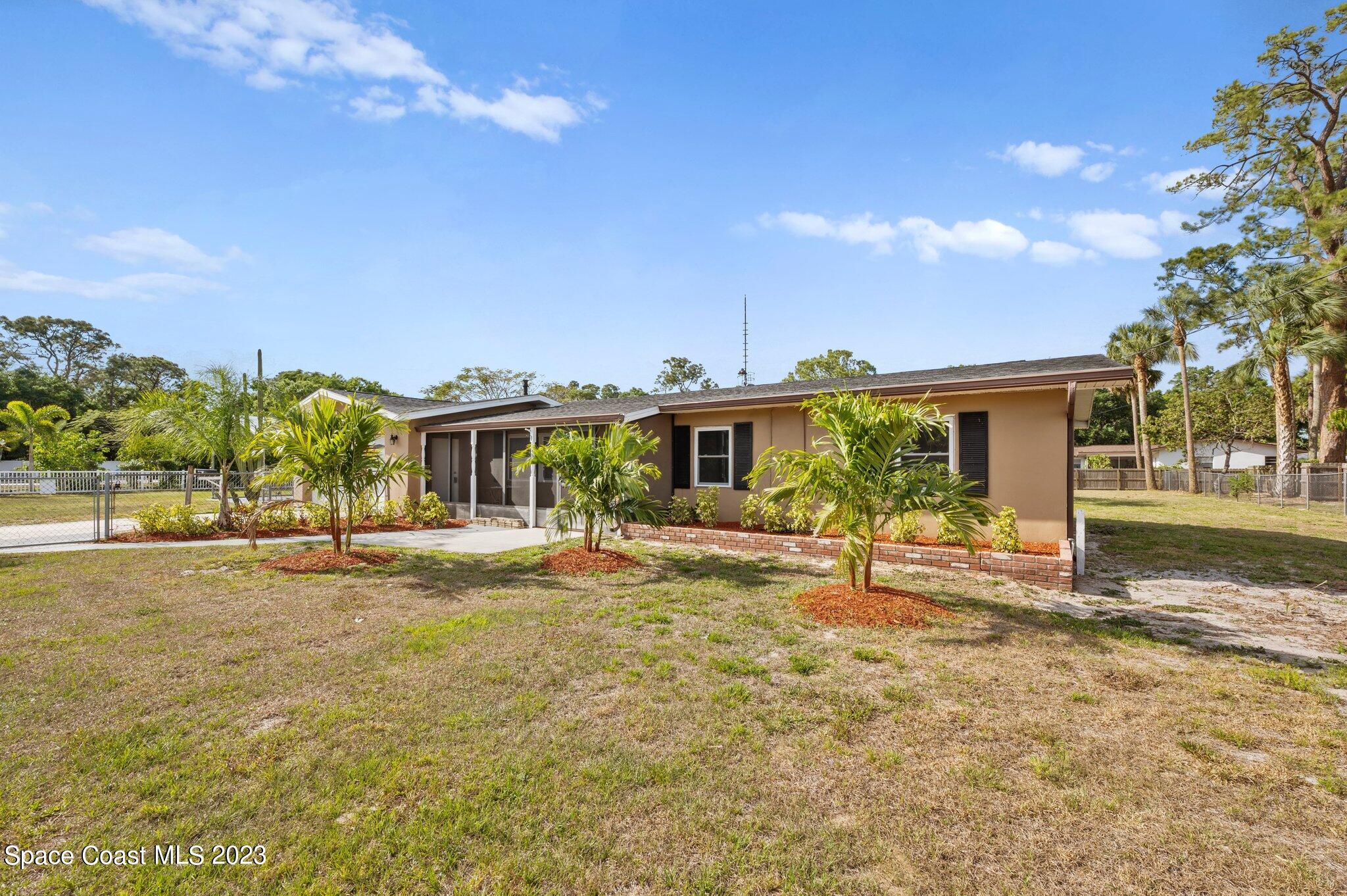 3030 Hield Road Melbourne, FL 32904 - Photo 18 of 36 a view of a house with backyard and sitting area