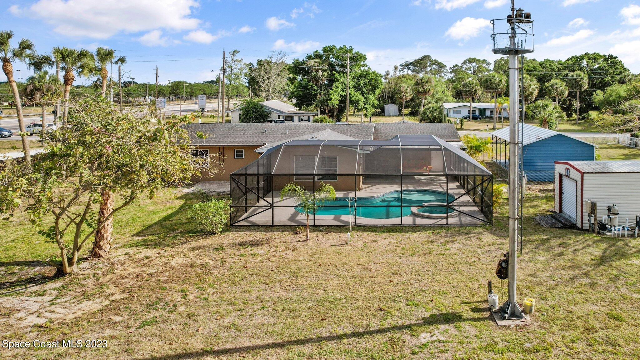 3030 Hield Road Melbourne, FL 32904 - Photo 23 of 36 a view of a house with a yard and potted plants