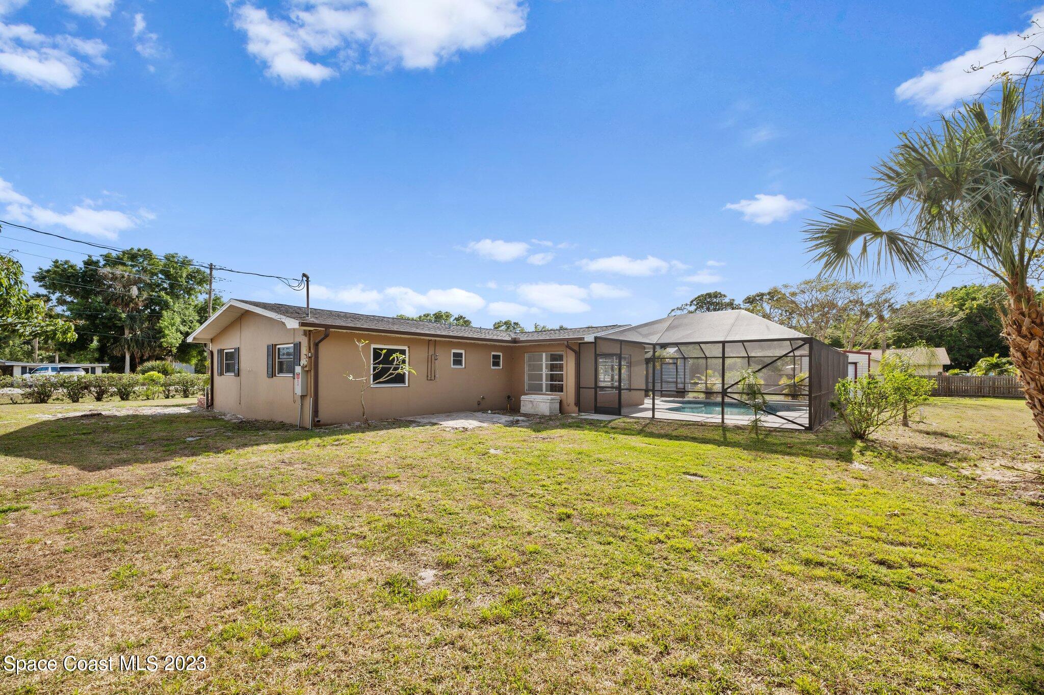 3030 Hield Road Melbourne, FL 32904 - Photo 26 of 36 a view of a house with a yard and a large tree
