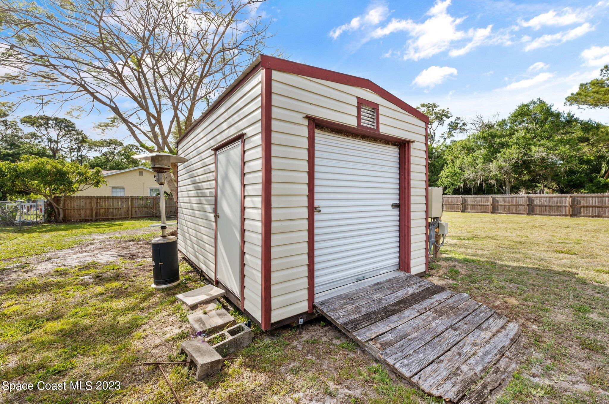 3030 Hield Road Melbourne, FL 32904 - Photo 32 of 36 a front view of a house with a yard