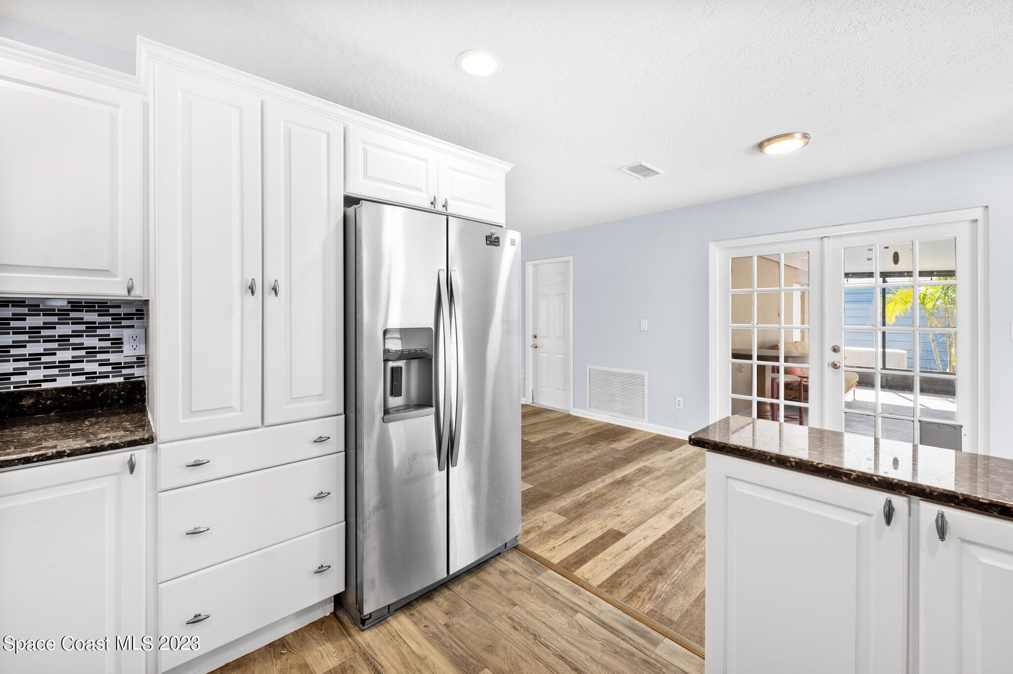3030 Hield Road Melbourne, FL 32904 - Photo 4 of 36 a kitchen with stainless steel appliances granite countertop a refrigerator and a stove top oven