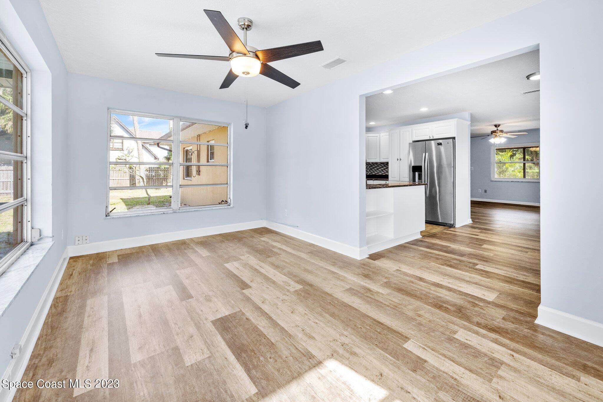 3030 Hield Road Melbourne, FL 32904 - Photo 6 of 36 a view of an empty room and window and wooden floor