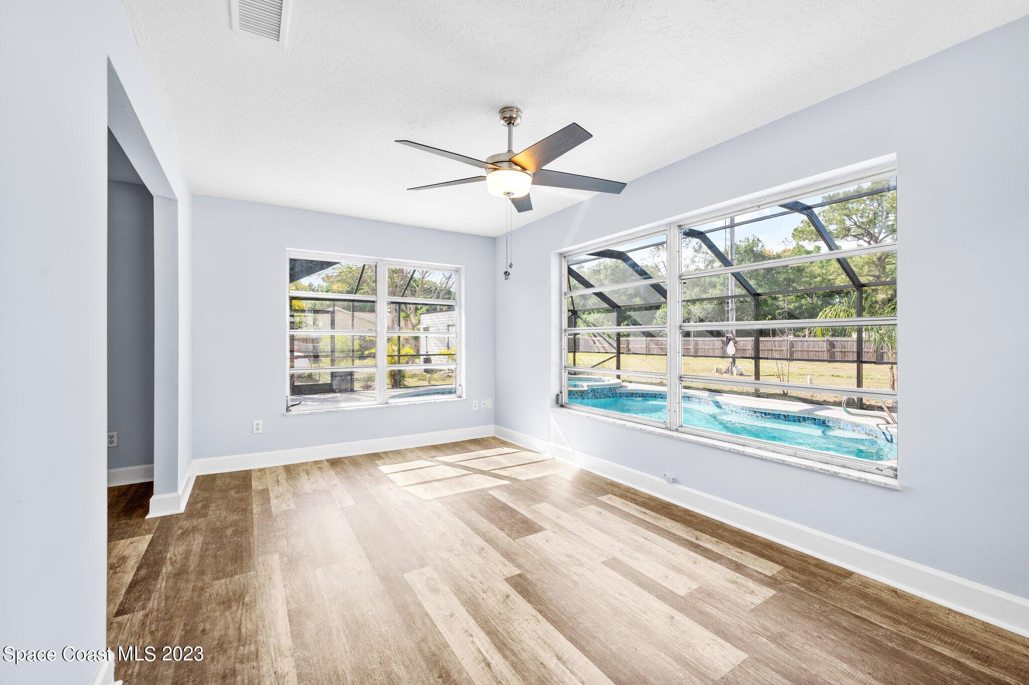 3030 Hield Road Melbourne, FL 32904 - Photo 7 of 36 a view of an empty room with a window and a ceiling fan