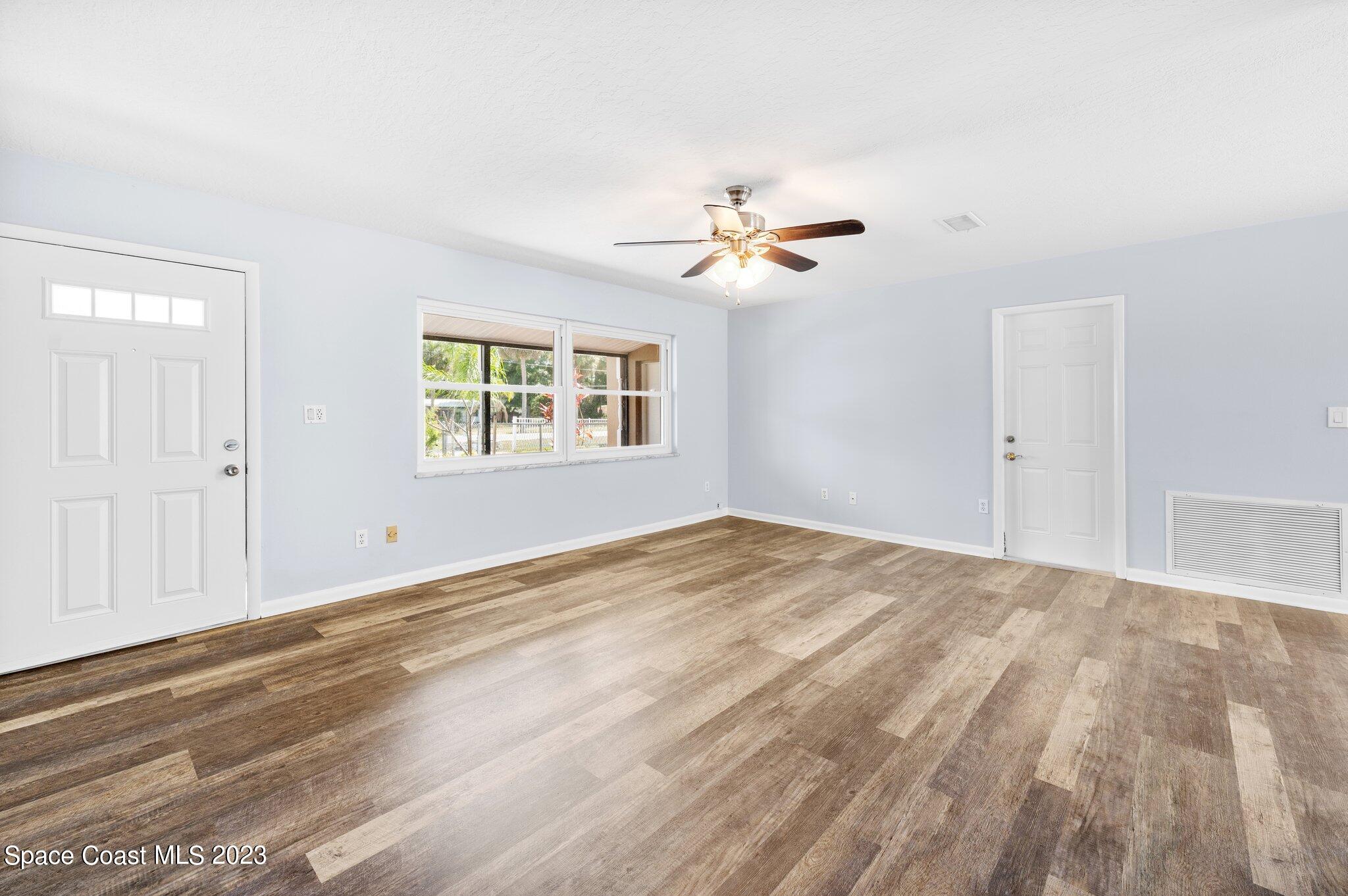 3030 Hield Road Melbourne, FL 32904 - Photo 8 of 36 a view of empty room with wooden floor and fan