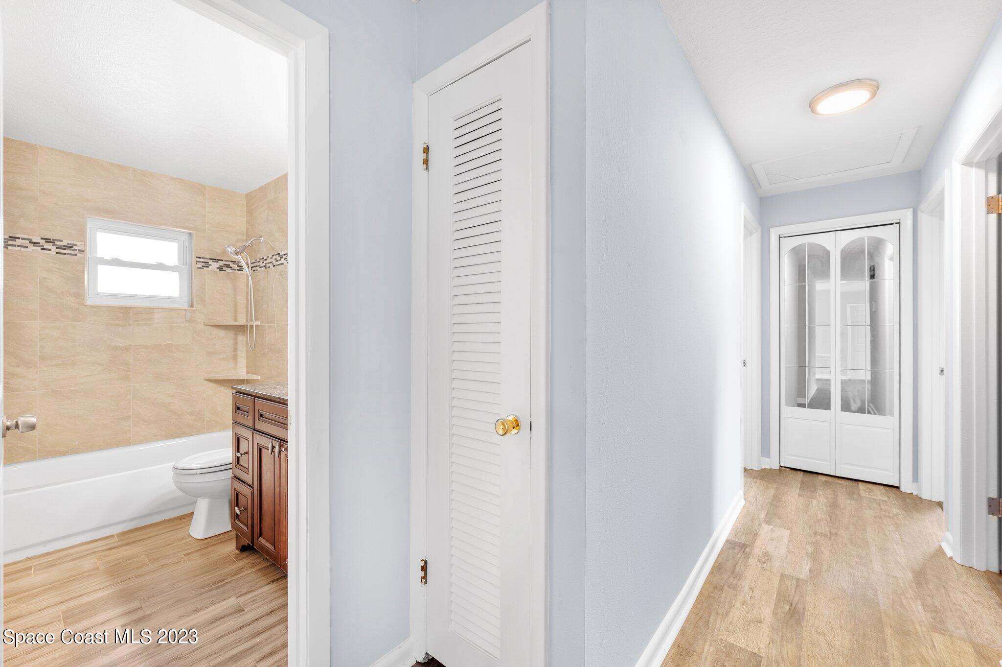 3030 Hield Road Melbourne, FL 32904 - Photo 9 of 36 a bathroom with a bathtub and a shower