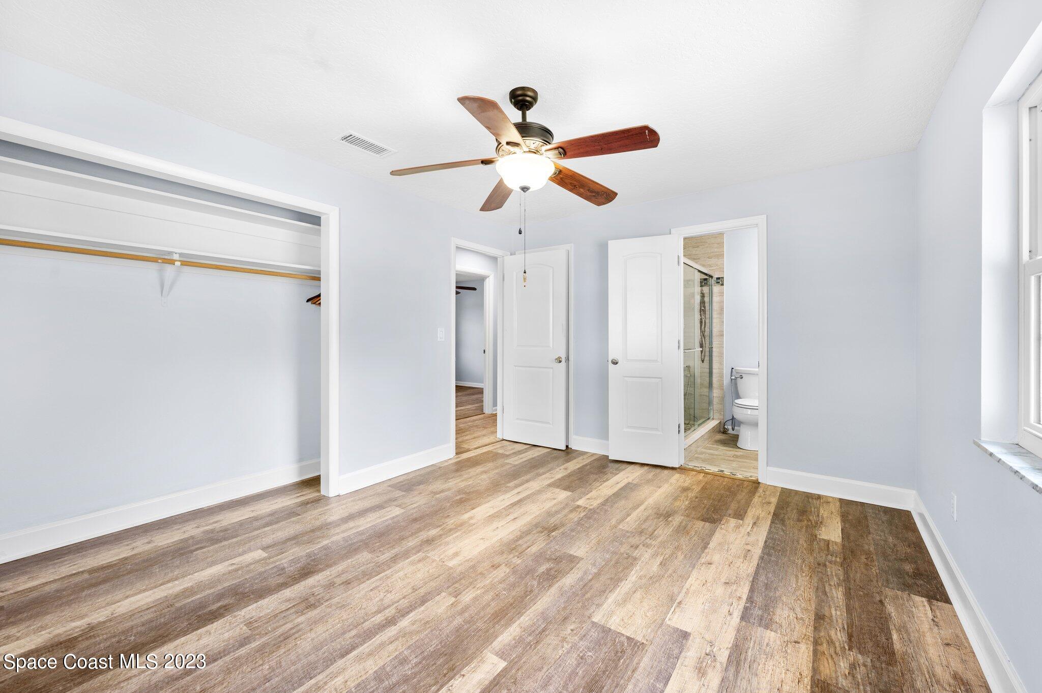 3030 Hield Road Melbourne, FL 32904 - Photo 10 of 36 a view of empty room with wooden floor and fan
