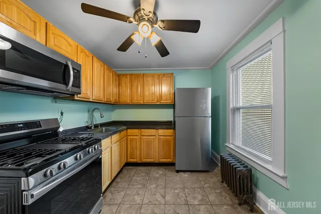 a kitchen with stainless steel appliances granite countertop a stove and a microwave