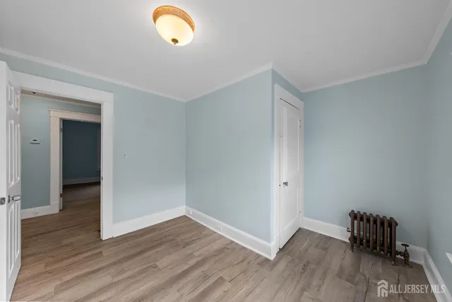 a view of room with wooden floor