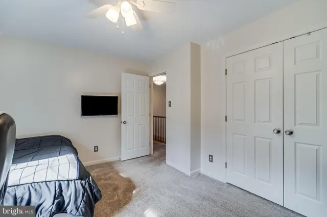 a view of a livingroom with a furniture and chandelier fan