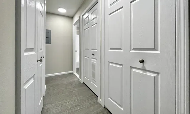 a view of a hallway with wooden floor