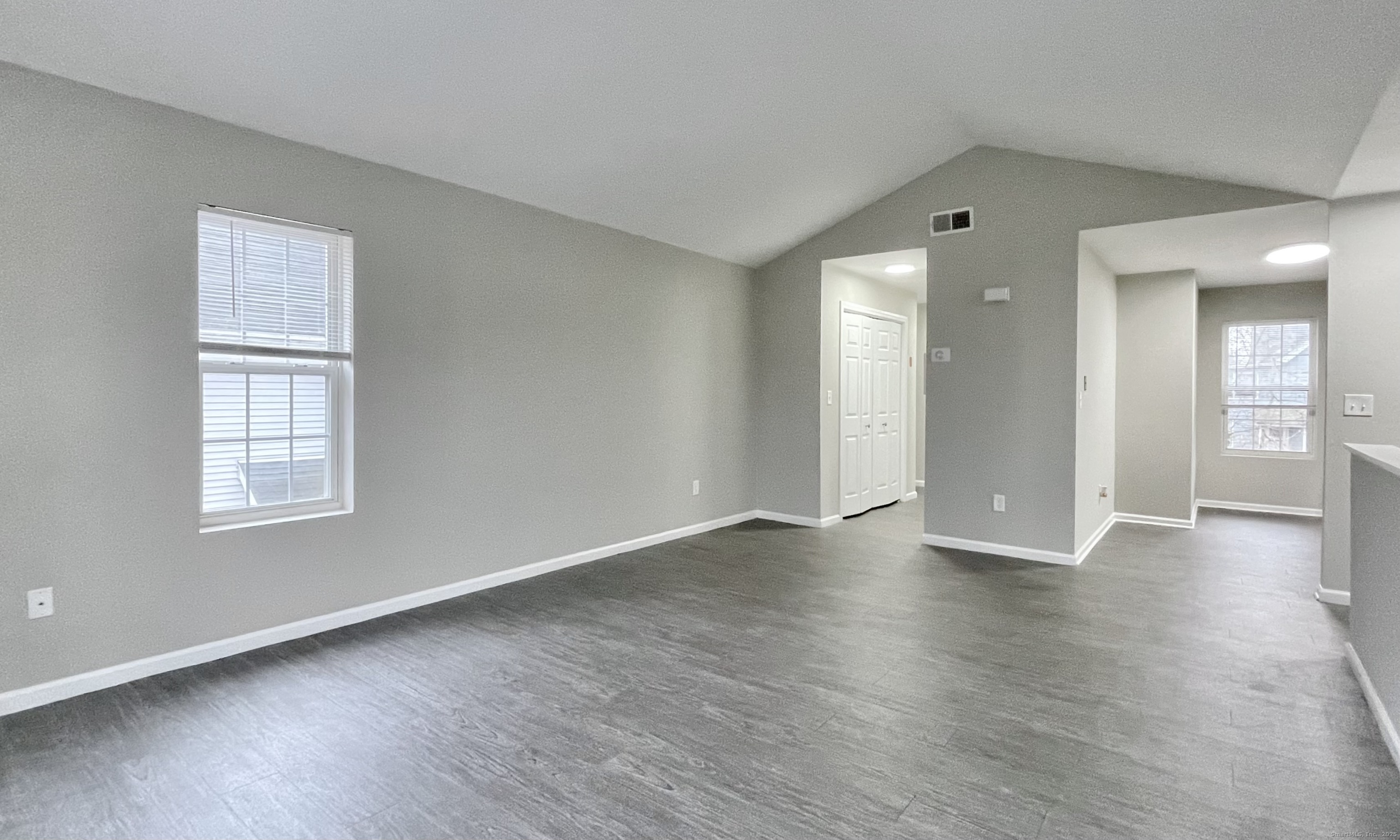 68 West Main Street Milford, CT 06460 - Photo 2 of 13 an empty room with wooden floor and windows