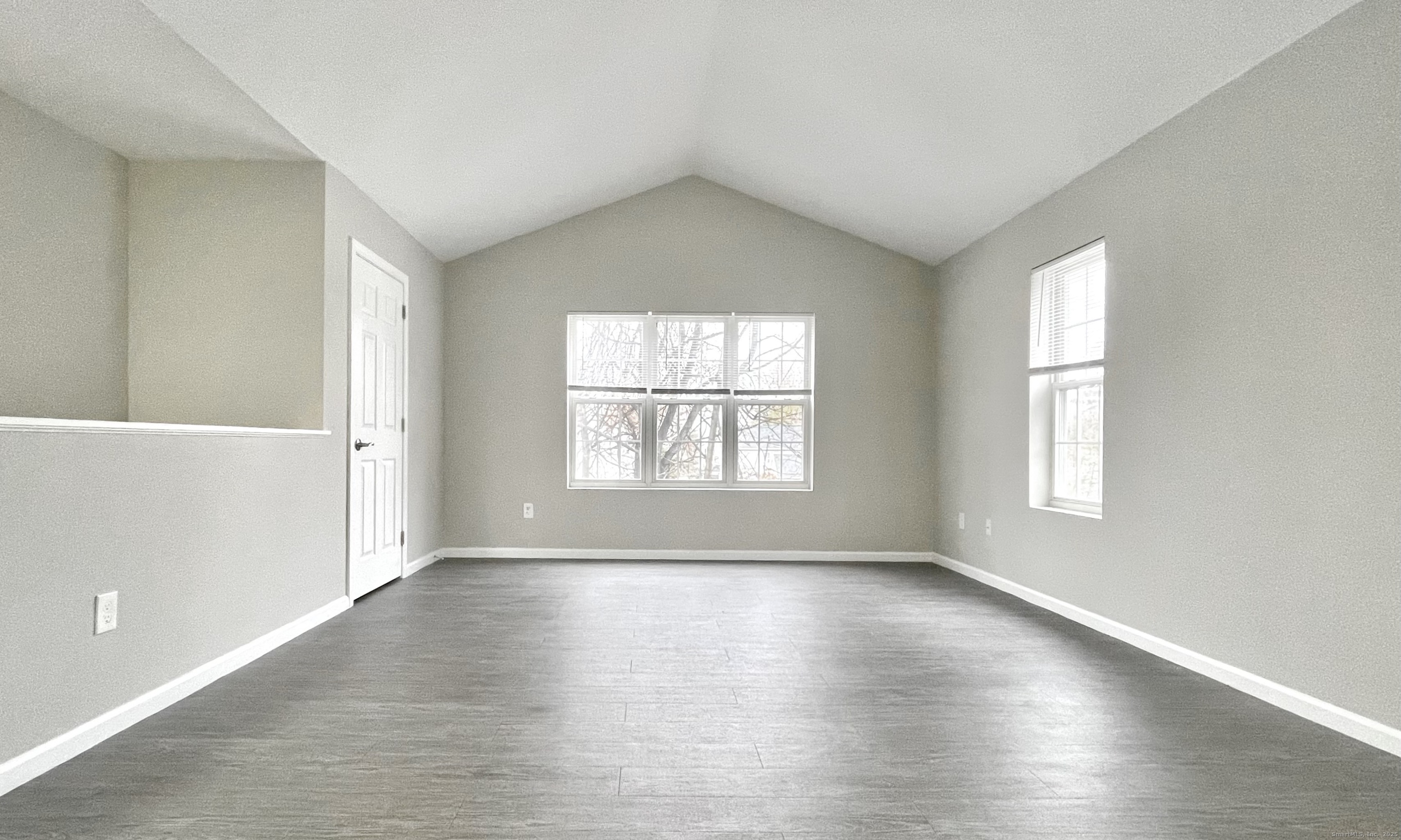 68 West Main Street Milford, CT 06460 - Photo 3 of 13 an empty room with wooden floor and windows
