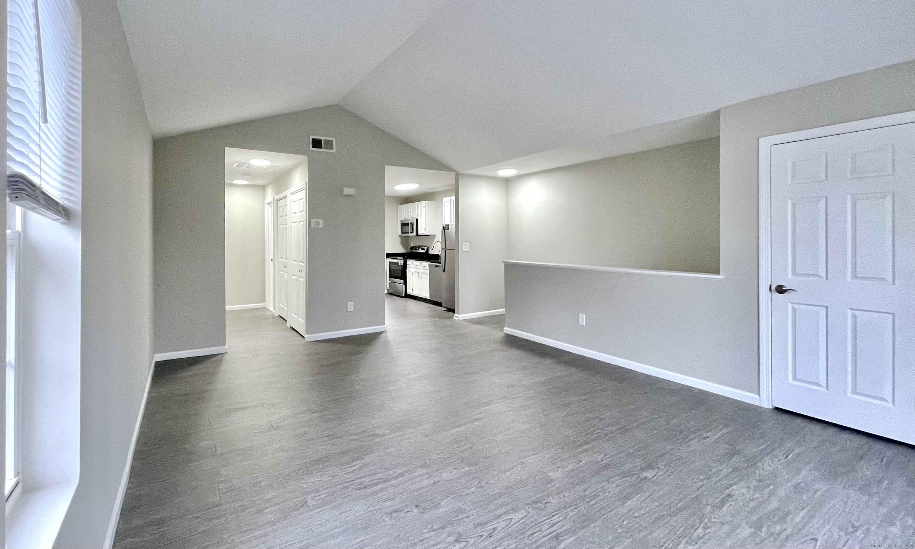 68 West Main Street Milford, CT 06460 - Photo 4 of 13 an empty room with wooden floor and windows