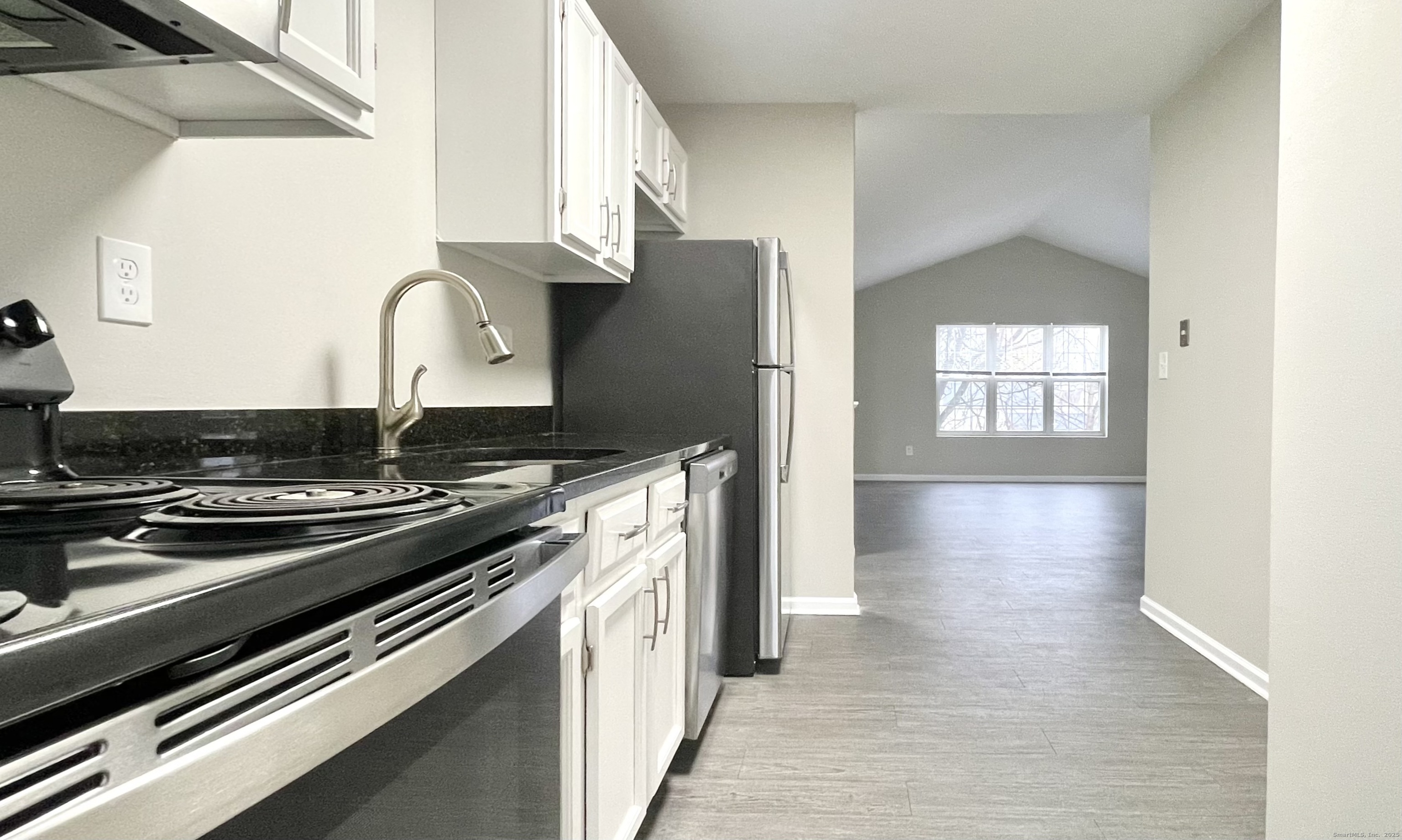 68 West Main Street Milford, CT 06460 - Photo 5 of 13 a kitchen with a stove and white cabinets