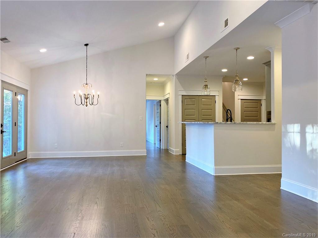 1501 Sierra Road York, SC 29745 - Photo 21 of 47 an empty room with wooden floor and entrance to kitchen