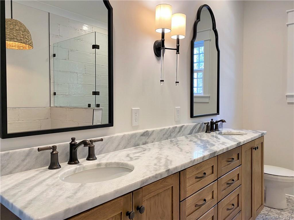 1501 Sierra Road York, SC 29745 - Photo 28 of 47 a bathroom with a granite countertop sink and a mirror