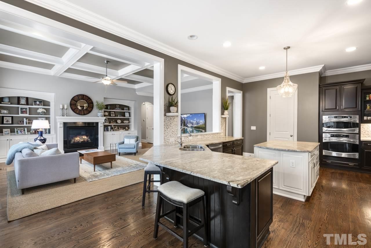 12212 Kyle Abbey Lane Raleigh, NC 27613 - Photo 11 of 30 a living room with fireplace furniture and a wooden floor