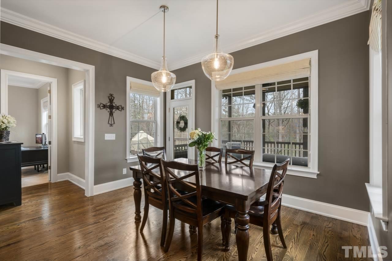 12212 Kyle Abbey Lane Raleigh, NC 27613 - Photo 12 of 30 a view of a dining room with furniture window and wooden floor