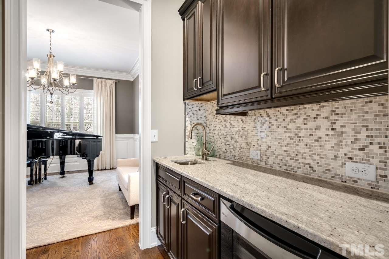 12212 Kyle Abbey Lane Raleigh, NC 27613 - Photo 13 of 30 a kitchen with a sink and cabinets