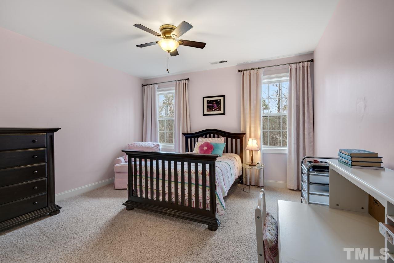 12212 Kyle Abbey Lane Raleigh, NC 27613 - Photo 25 of 30 a view of a bedroom with furniture window and a ceiling fan