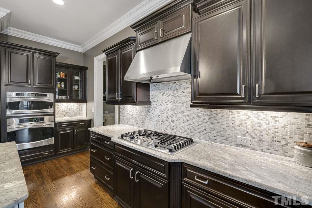 12212 Kyle Abbey Lane Raleigh, NC 27613 - Photo 8 of 30 a kitchen with stainless steel appliances granite countertop a stove and a microwave