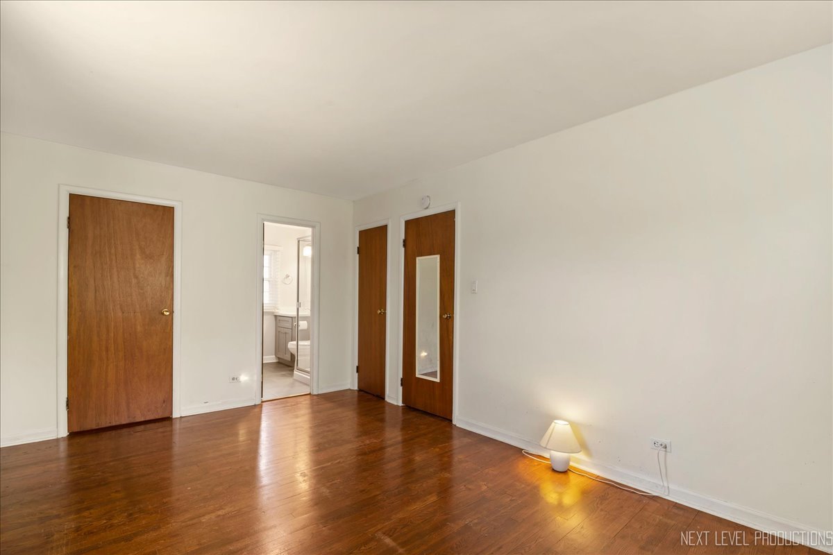 515 Hillcrest Boulevard Hoffman Estates, IL 60169 - Photo 11 of 29 a view of an empty room with wooden floor and closet