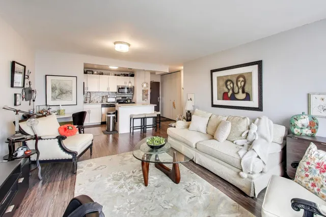 a living room with furniture and kitchen view